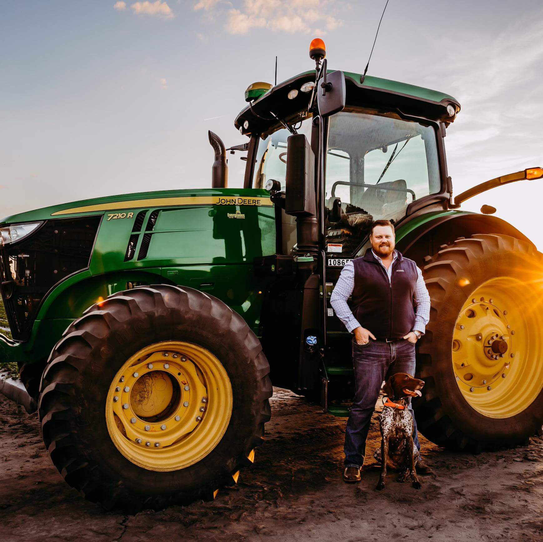 Konnore Long, owner of Long's Land Management, with his John Deere tractor and dog
